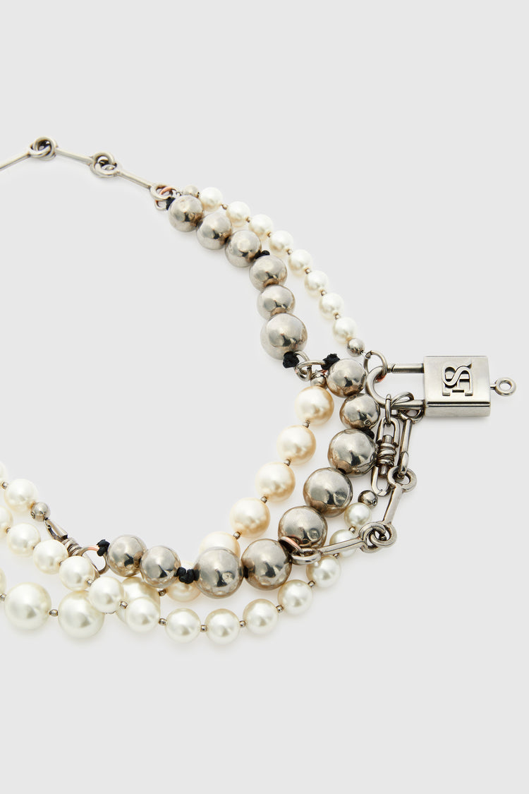 Multi-strand necklace with mix of pearls, glass, and hand-hammered metal beads - silver tone