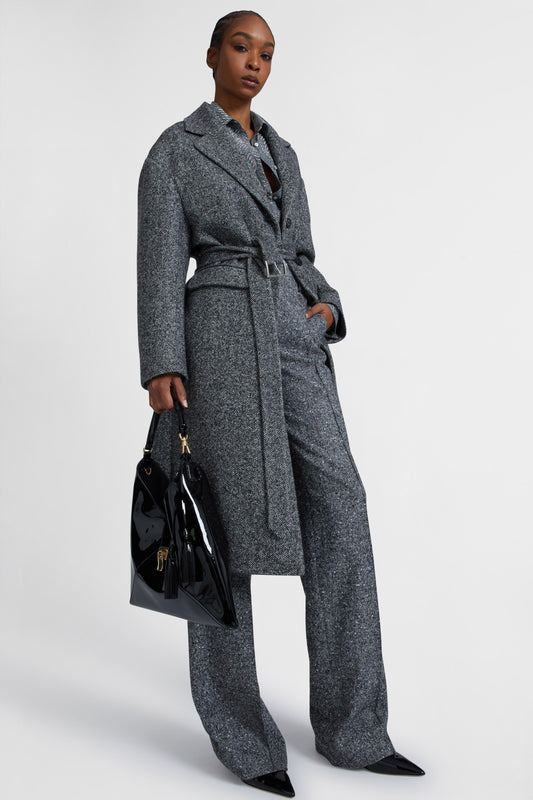 Single-breasted tailored coat with a masculine fit and belt at the waist