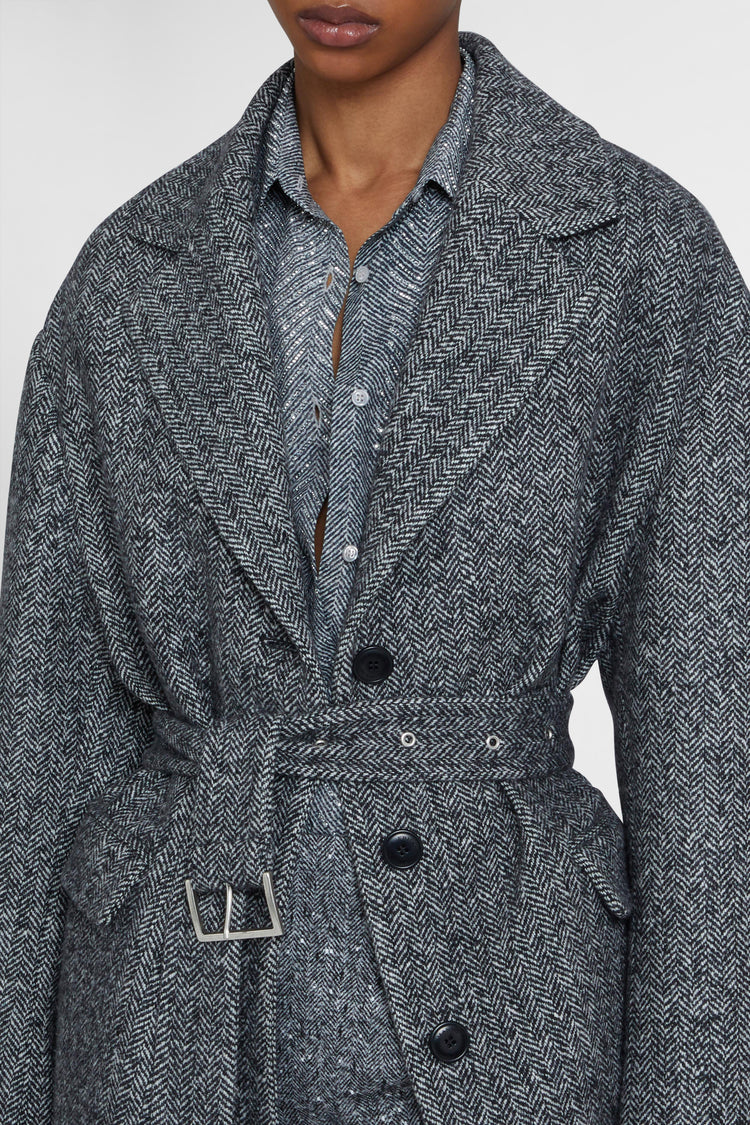 Single-breasted tailored coat with a masculine fit and belt at the waist