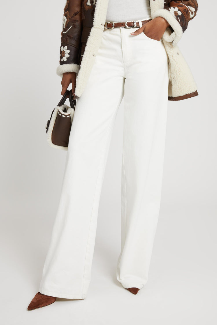 Pantalone palazzo in denim bianco con cut out floreale