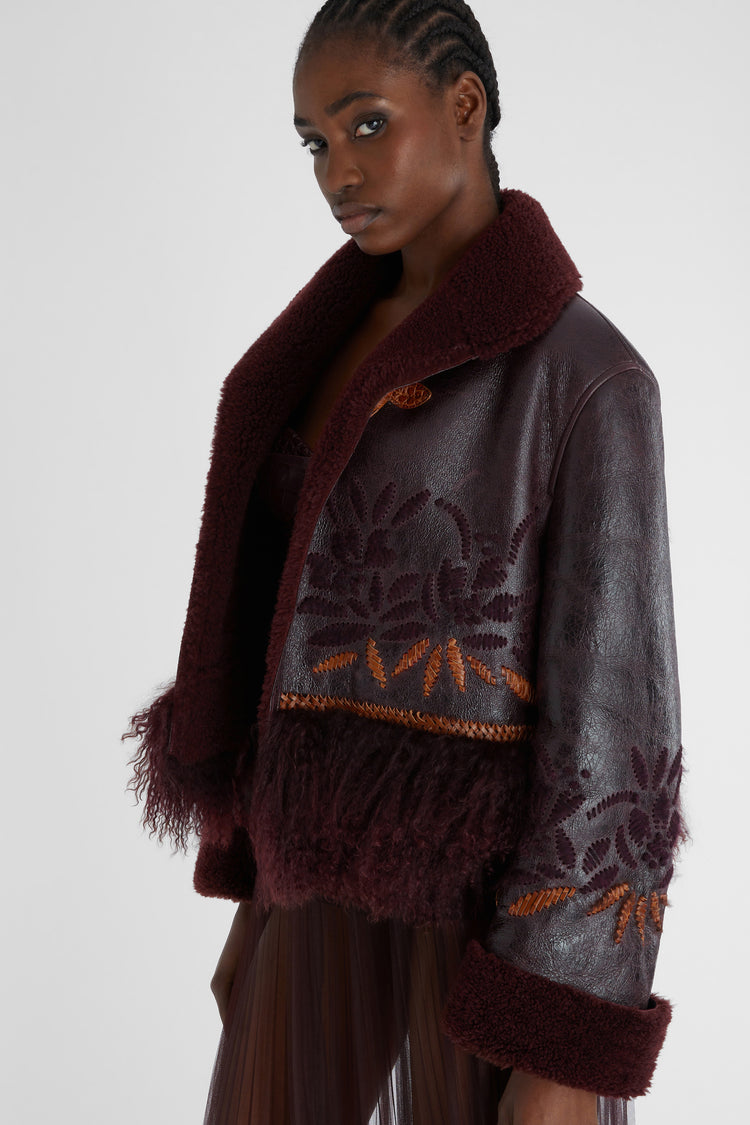 Short single-breasted shearling with handmade embroidery and fur on the bottom