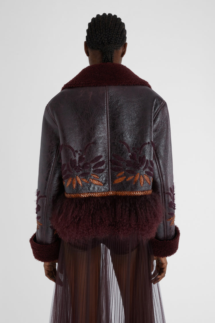 Short single-breasted shearling with handmade embroidery and fur on the bottom