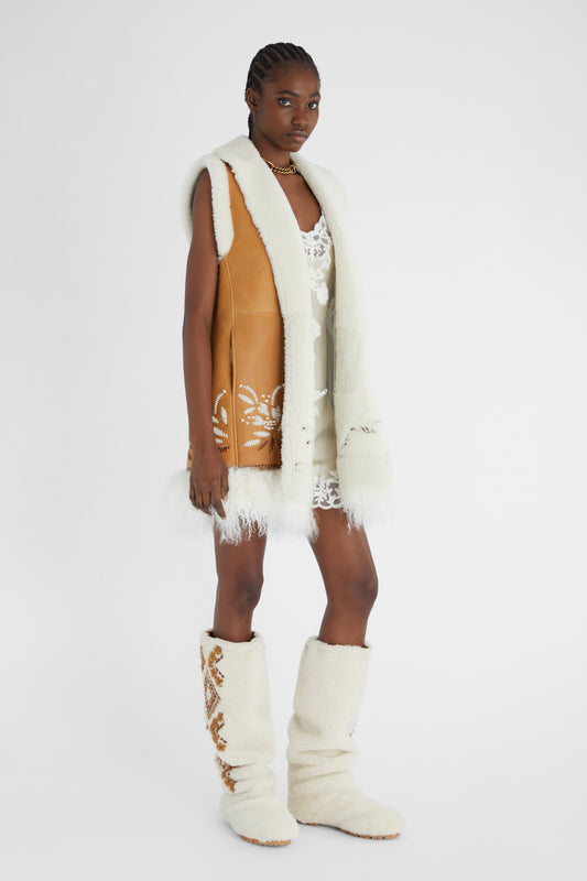 Shearling long waistcoat with handmade embroidery and fur on the bottom