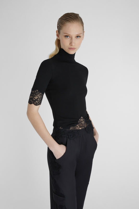 Turtleneck with lace applications.