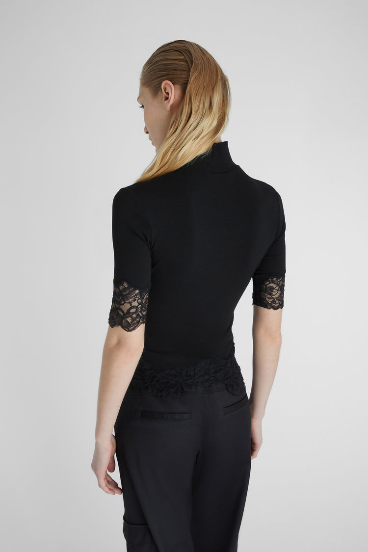 Turtleneck with lace applications.