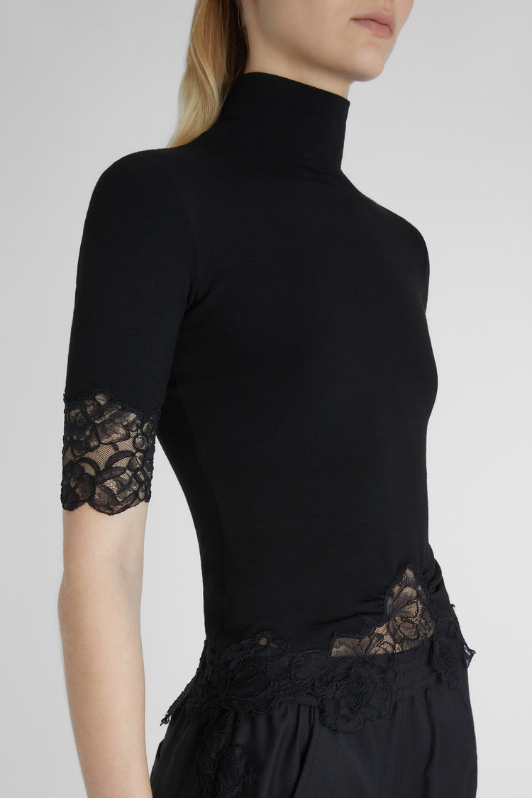 Turtleneck with lace applications.