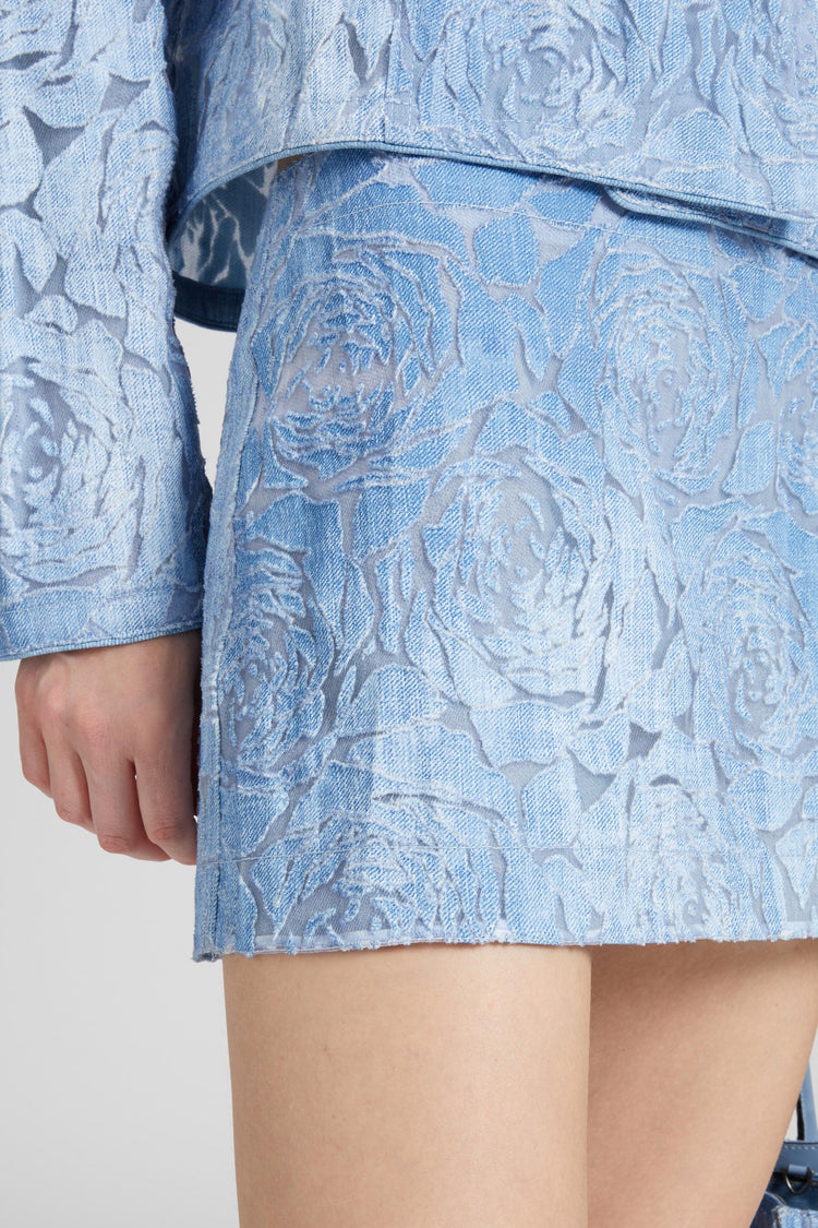 Denim miniskirt with devoré floral pattern