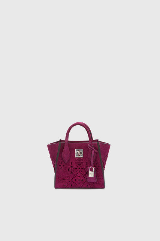 Mini Maggie in magenta-coloured crust leather with geometric carvings with a jour effect made and finished by hand