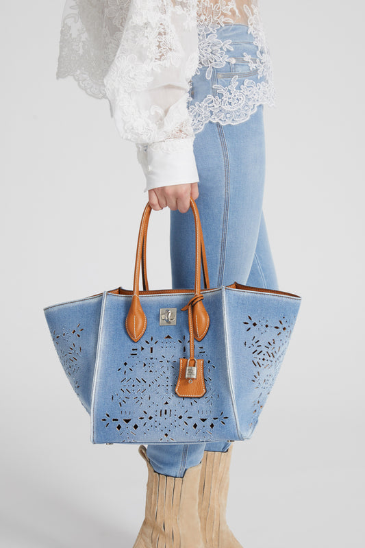 Medium Maggie in denim with handmade and hand-finished geometric cut-out