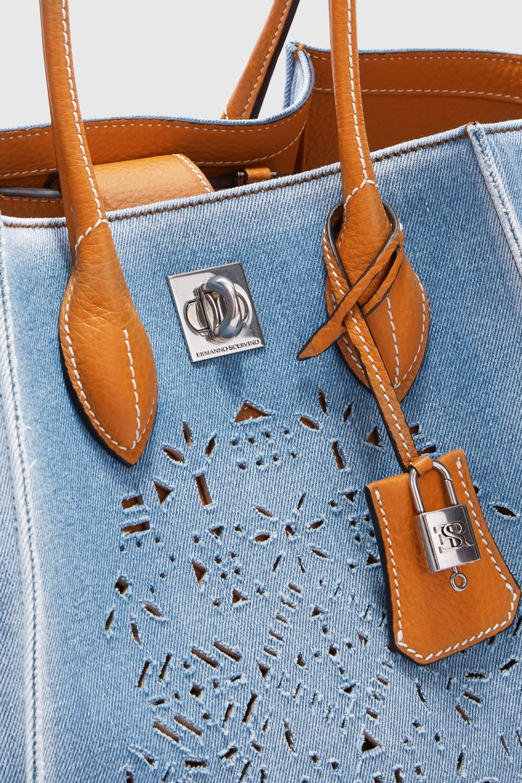 Medium Maggie in denim with handmade and hand-finished geometric cut-out