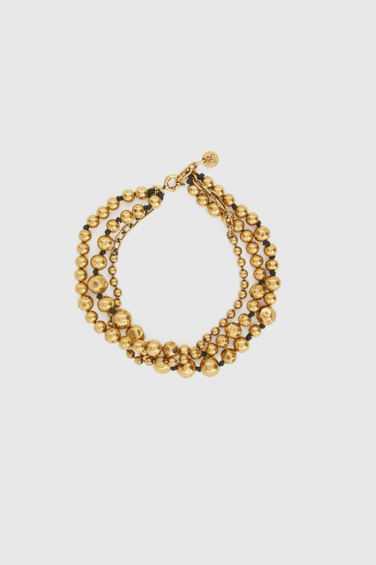 Three-strand necklace of gold metal pearls