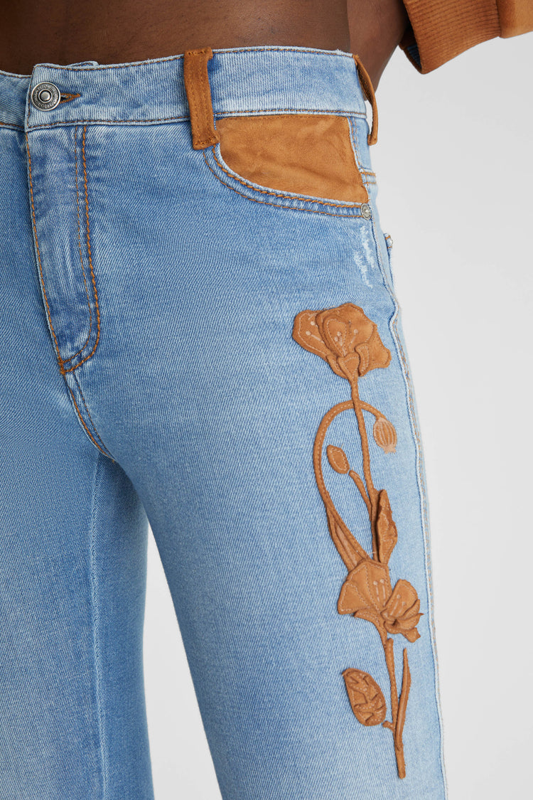 Slim fit jeans with floral details handmade in suede and rafia