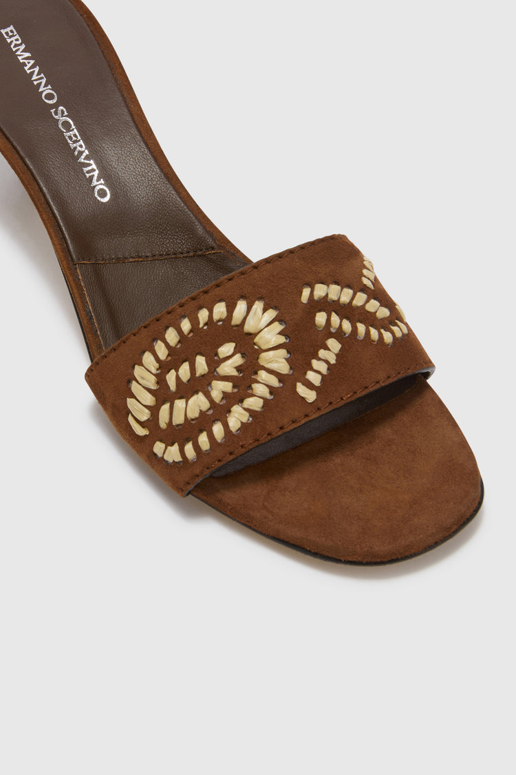 Suede mule with hand-embroidered floral details in natural rafia