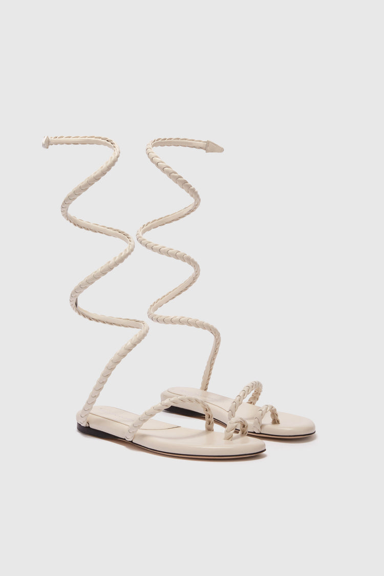 Flat sandal in smooth calfskin with hand-woven lacing