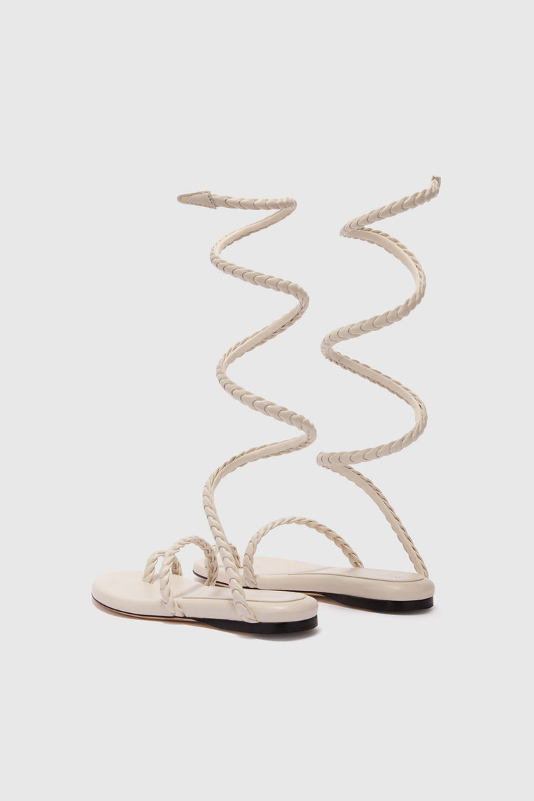 Flat sandal in smooth calfskin with hand-woven lacing