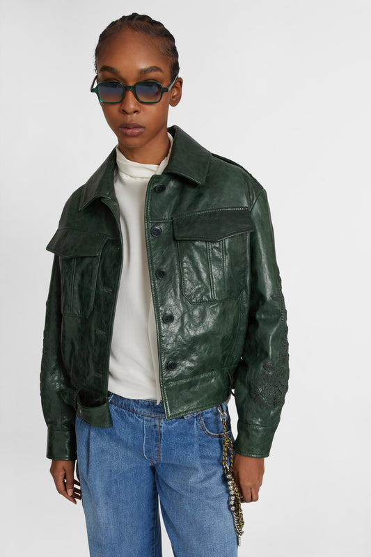 Single-breasted leather jacket with front pockets and handmade floral embroidery