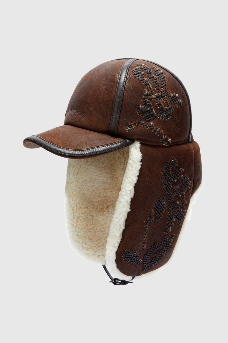 Embroidered baseball-style hat with shearling ear flaps