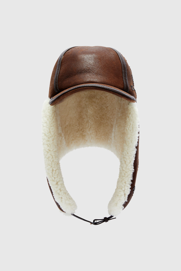 Embroidered baseball-style hat with shearling ear flaps