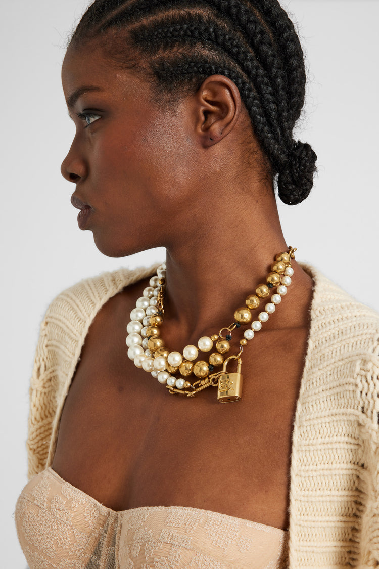 Multi-strand necklace with mix of pearls, glass, and hand-hammered metal beads - gold tone
