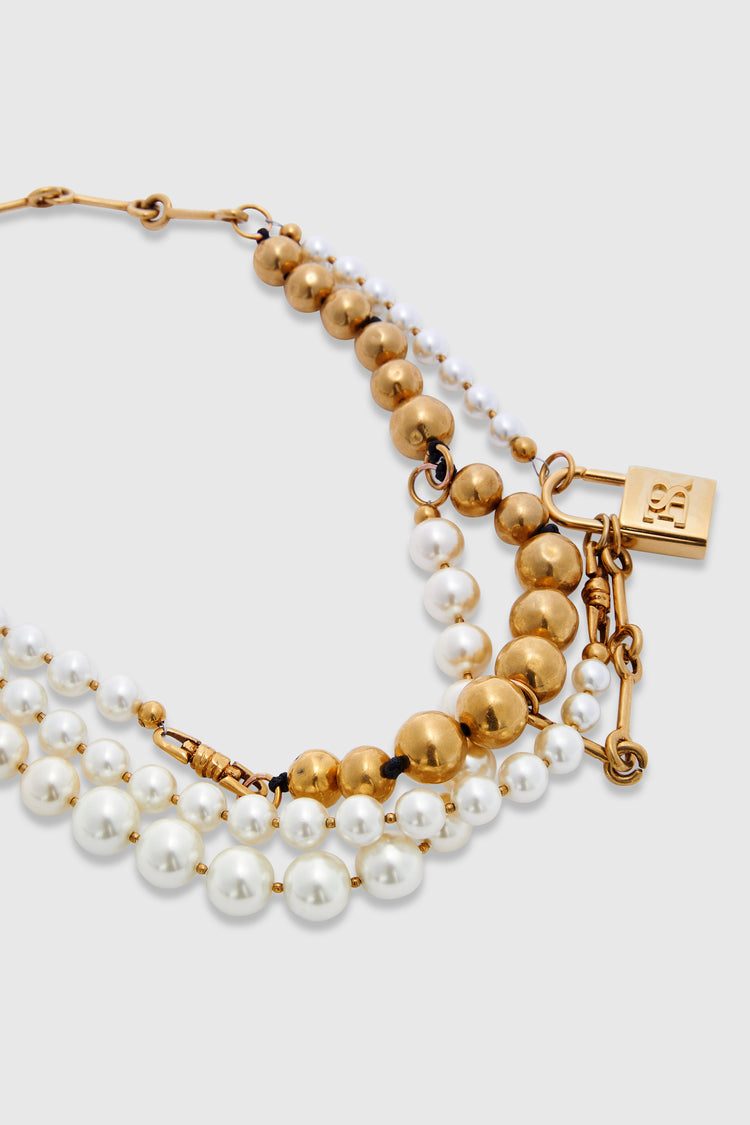 Multi-strand necklace with mix of pearls, glass, and hand-hammered metal beads - gold tone