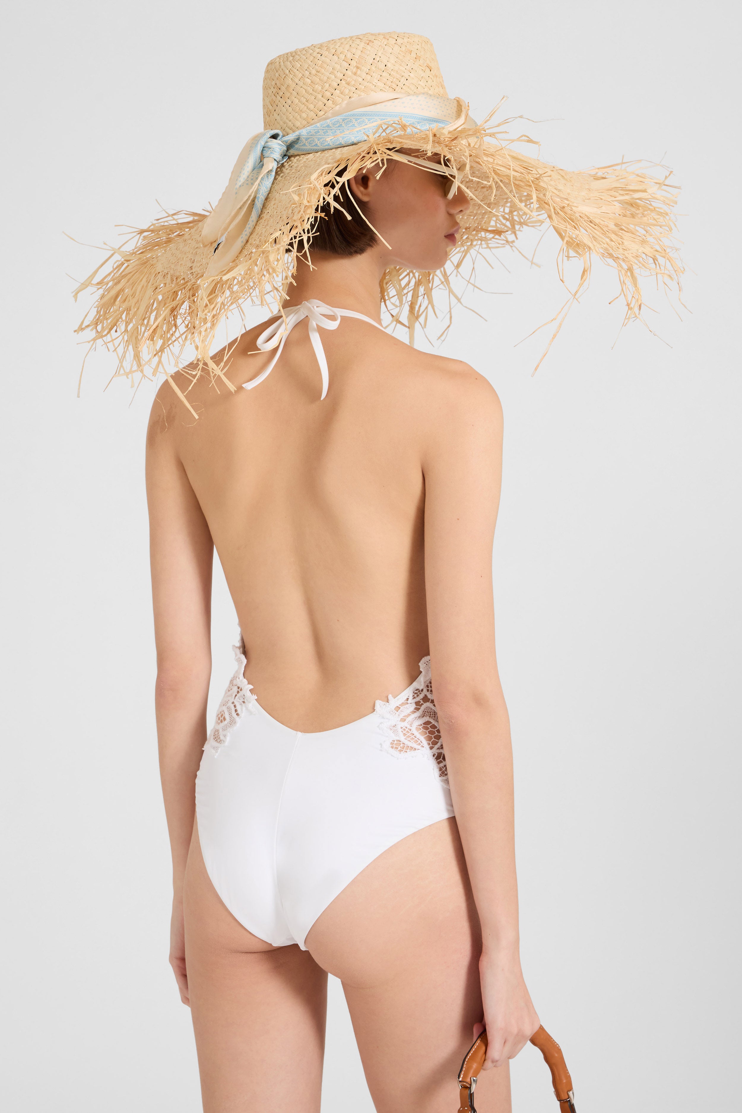 One-piece swimsuit with V-neck and macramé lace inserts