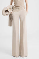 Wide-leg tailored trousers with heraldic buttons