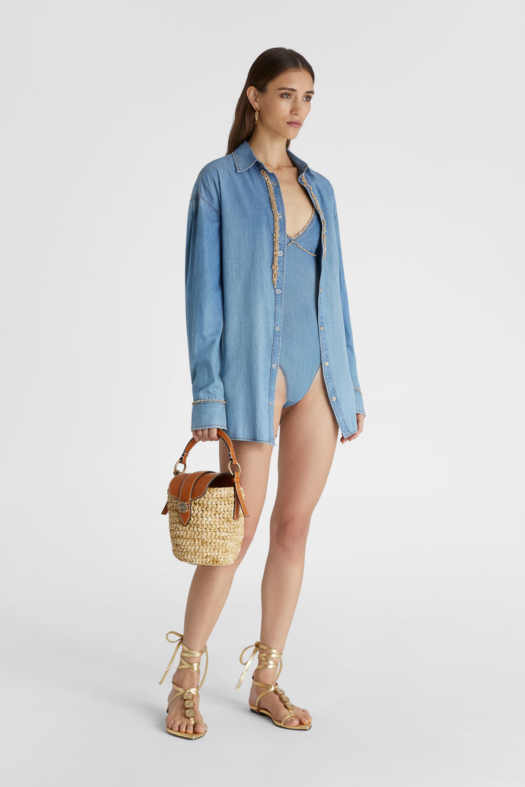 Model in oversized Denim Button-up shirt in pure cotton chambray featuring gold chain piping