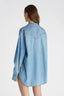 Rear view of model in Oversized Denim Button-up shirt featuring gold chain piping