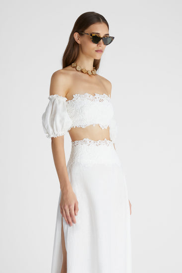 Model in white linen crop top with balloon sleeves and cotton macramé lace inlay