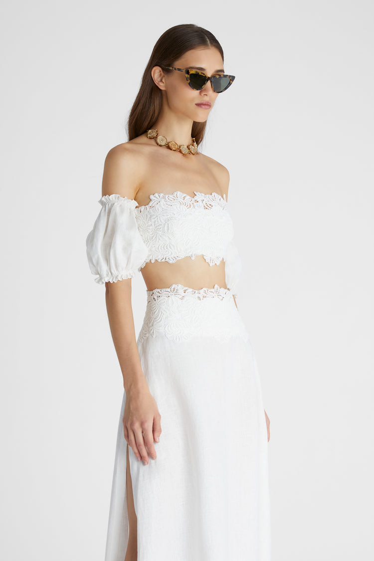 Model in white linen crop top with balloon sleeves and cotton macramé lace inlay