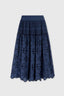 Long skirt in navy muslin broderie anglaise, with peplum and scalloped hem.