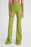 Waist of model in green flared macramé palazzo trousers with small concealed side zip