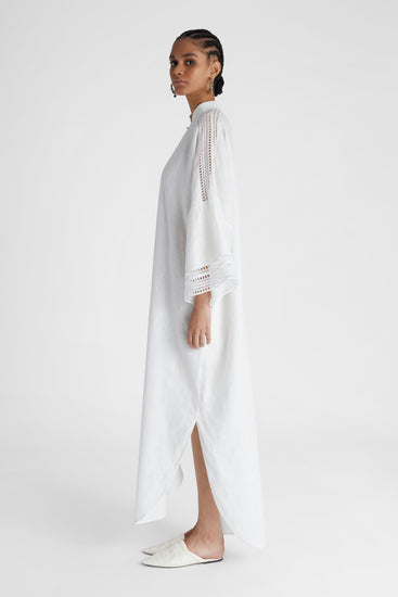 Model's side profile showcasing pure linen White Kaftan with cap sleeves and embroidery