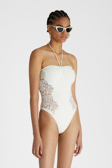 Model in White one-piece swimsuit with macramé and removable shoulder and neck straps