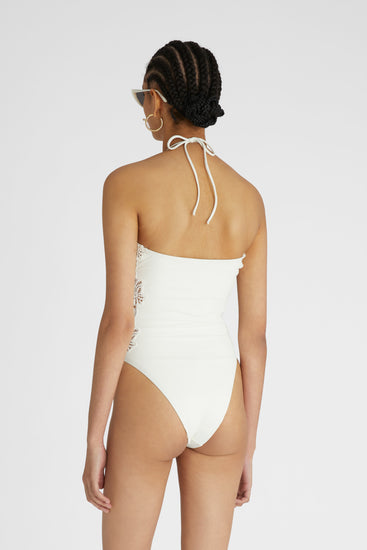 Rear view of model in White one-piece swimsuit with macramé and removable shoulder and neck straps