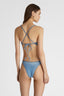 Model showcasing Denim Trikini One-piece with sretch gold piping and strings on the back
