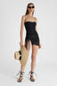 Full body shot of model in black one-piece macramé swimsuit with removable straps and a sequin ribbon.