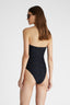 Rear view of model in black one-piece macramé swimsuit with removable straps and a sequin ribbon.
